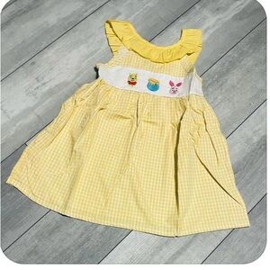 Disney is innie the Pooh dress. New with out tags